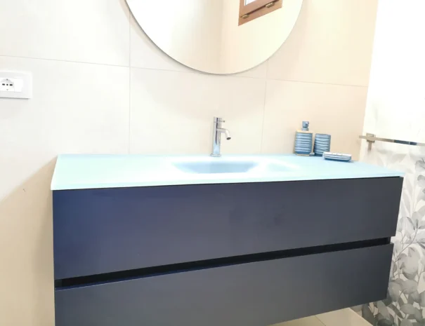 Sanitari e specchio con illuminazione LED nel bagno della casa vacanze Soli